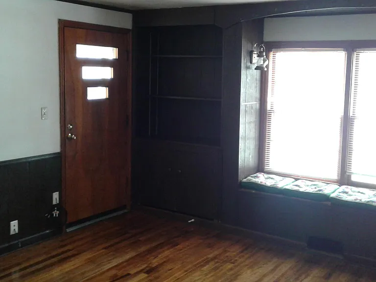 Front entry into living room next to window box seats.