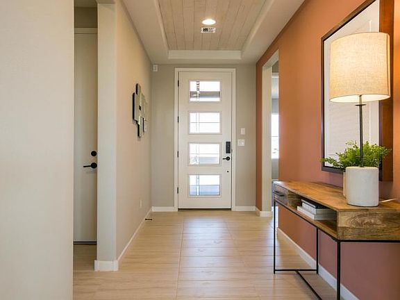 Welcome to the Tifton Walk home design with accented tray ceiling in the foyer and modern front door