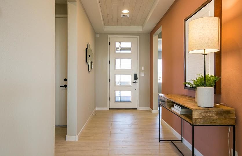Welcome to the Tifton Walk home design with accented tray ceiling in the foyer and modern front door
