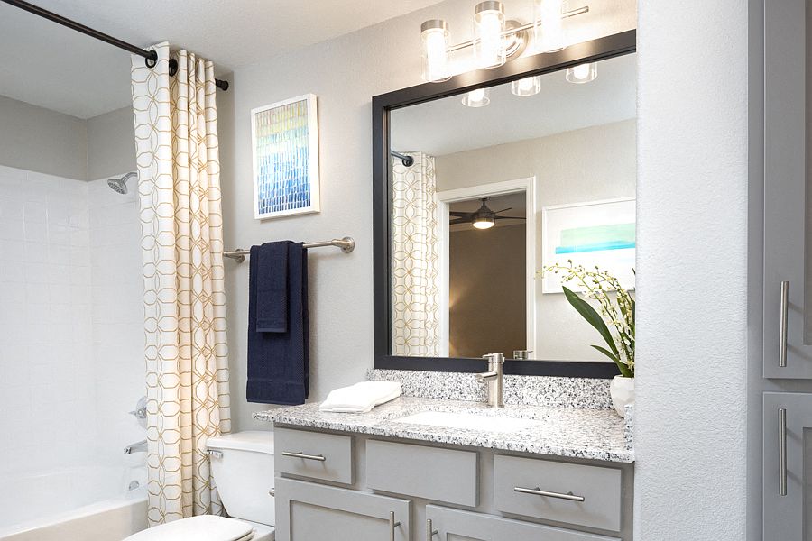 Contemporary bathrooms with framed mirrors