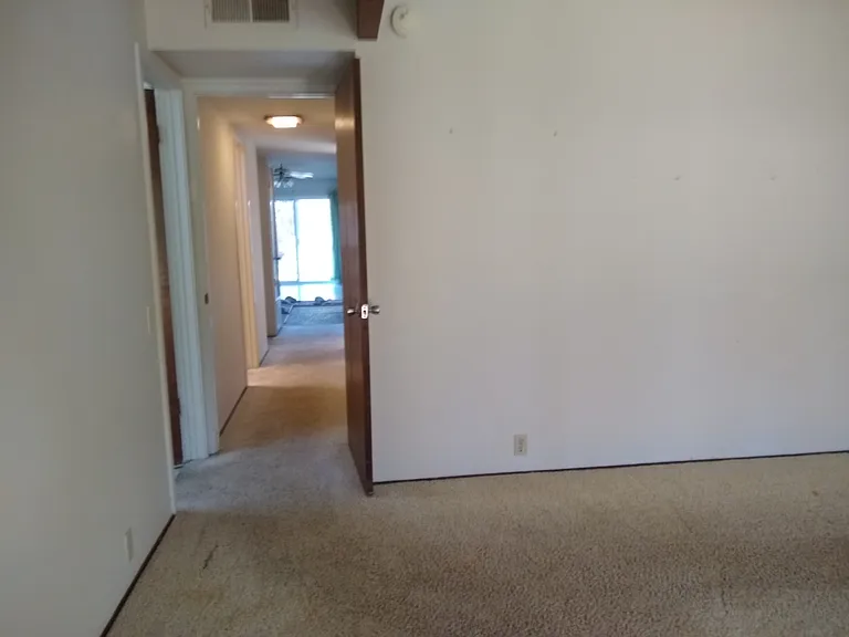 Primary bedroom, looking back down the hallway.