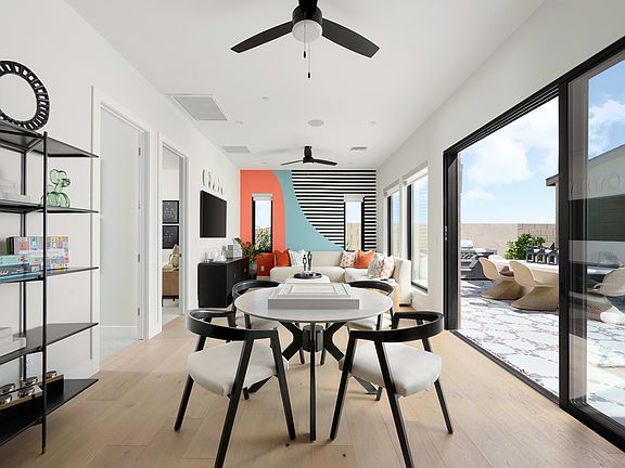 A modern and minimalist living space with a dining area, featuring a white and black color scheme, s