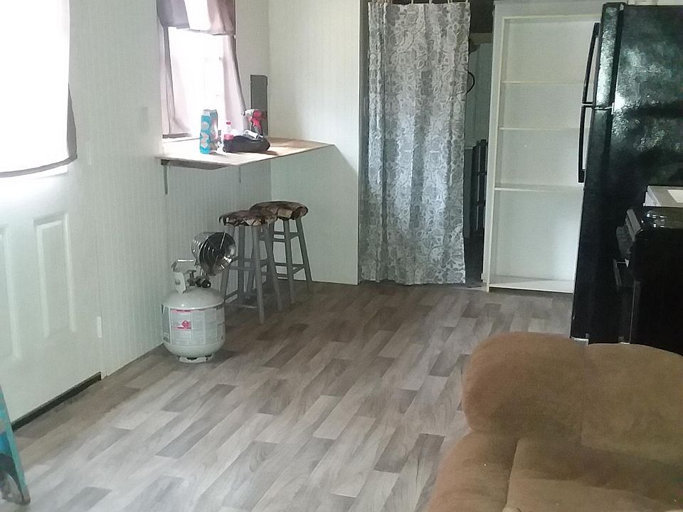 Area photo of kitchen and bathroom entrance. Propane tank is NOT the source of heat. It was used while construction was underway. Home is total electric.