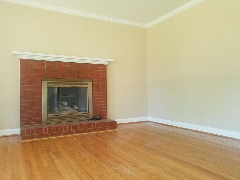 Living room has a gas fireplace and hardwood floors