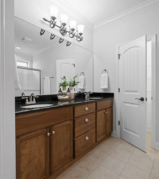 Master bedroom bath with double vanity, linen closet and granite counter tops.