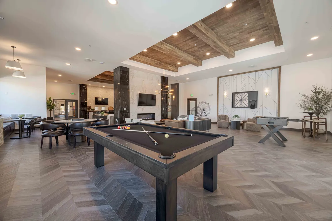 The resident clubhouse at Garrett Parker includes a full size billiards table, foosball table, and fireplace lounge for casual games and gathering.