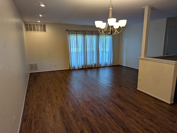View from the front door, looking past the dining area into the living area. The kitchen is to the right.