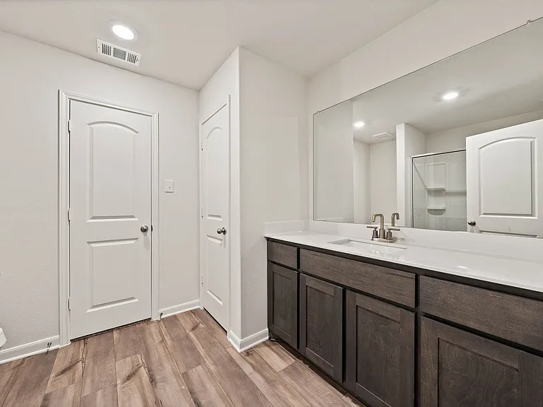 The master bathroom has a sprawling vanity space.