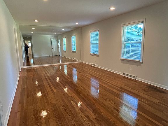 Very large living room with newly refinished hardwood flooring
