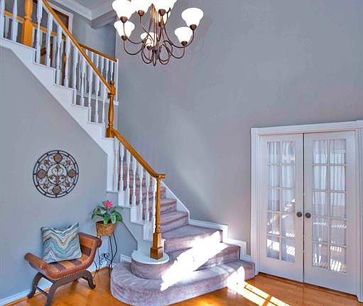 As the door opens, you see wood floors, crisp moldings, iron chandelier, soaring ceilings and a picture-perfect staircase.