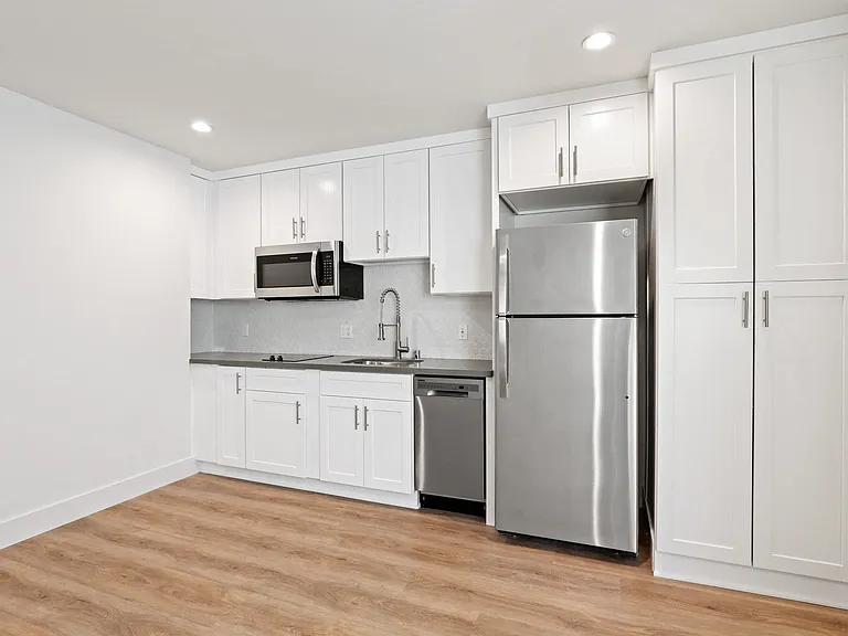 Studio Apartment Kitchen including Dishwasher, Full-Size Refrigerator, and Microwave Oven