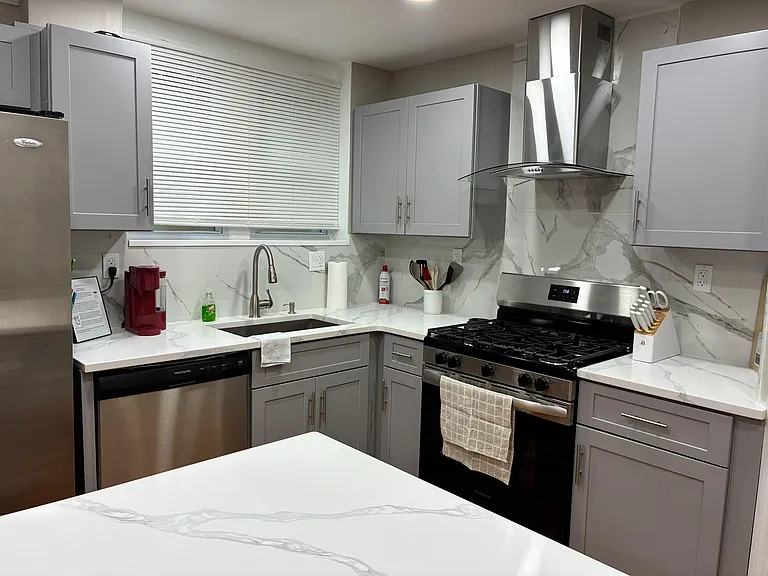 Updated kitchen with stainless-steel gas range, dishwasher, ample cabinetry, and generous counter space for meal prep.