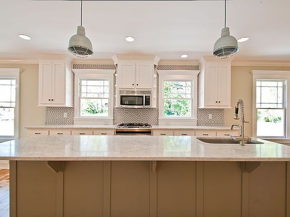 Designer Kitchen with Marble Countertops and recycled glass back-splash.