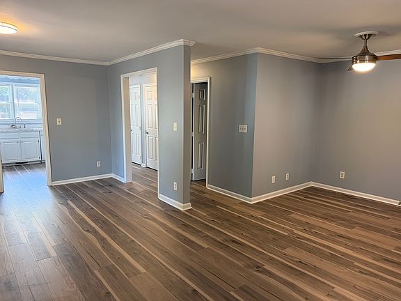 Open concept main floor. Livingroom space in right side of picture and dining space in left side of picture. Half bath, laundry room and hall closet doors pictured.