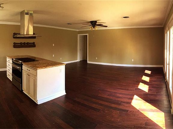 Den accommodates multiple furniture arrangements and is open