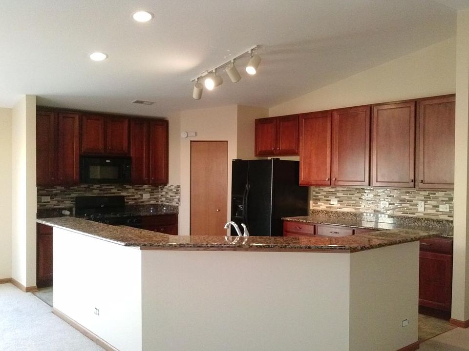 huge kitchen with 42-inch cherry cabinets, granite counterto
