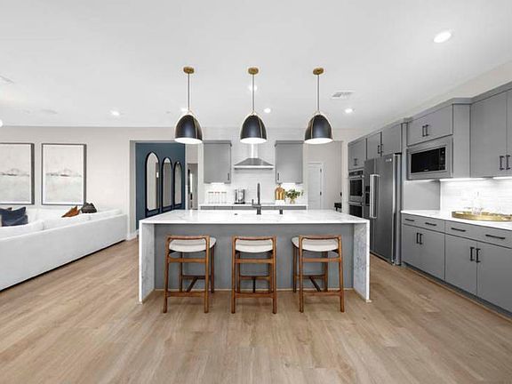 Kitchen with waterfall edge island and eat-in bar top