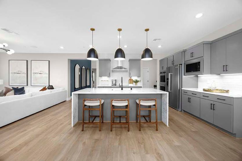 Kitchen with waterfall edge island and eat-in bar top
