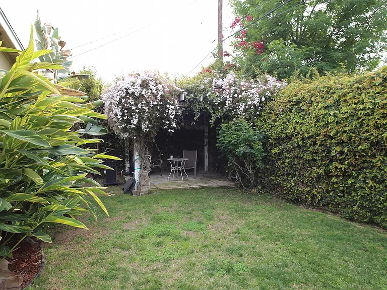This photo illustrates about half of the backyard with a patio and covered pergola. 2nd patio not shown.
