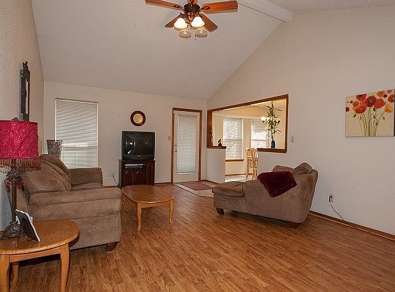 Vaulted ceiling and wood laminate floor in living