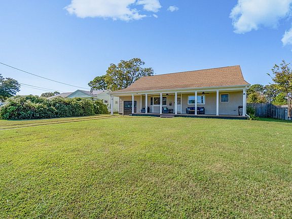 Enormous front porch and flat grassy yard