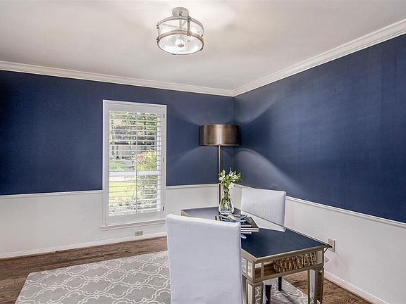 This study measuring 13' x 13' can be used as a flex space. It's super chic with its paint color, wainscoting, wood flooring and natural light.