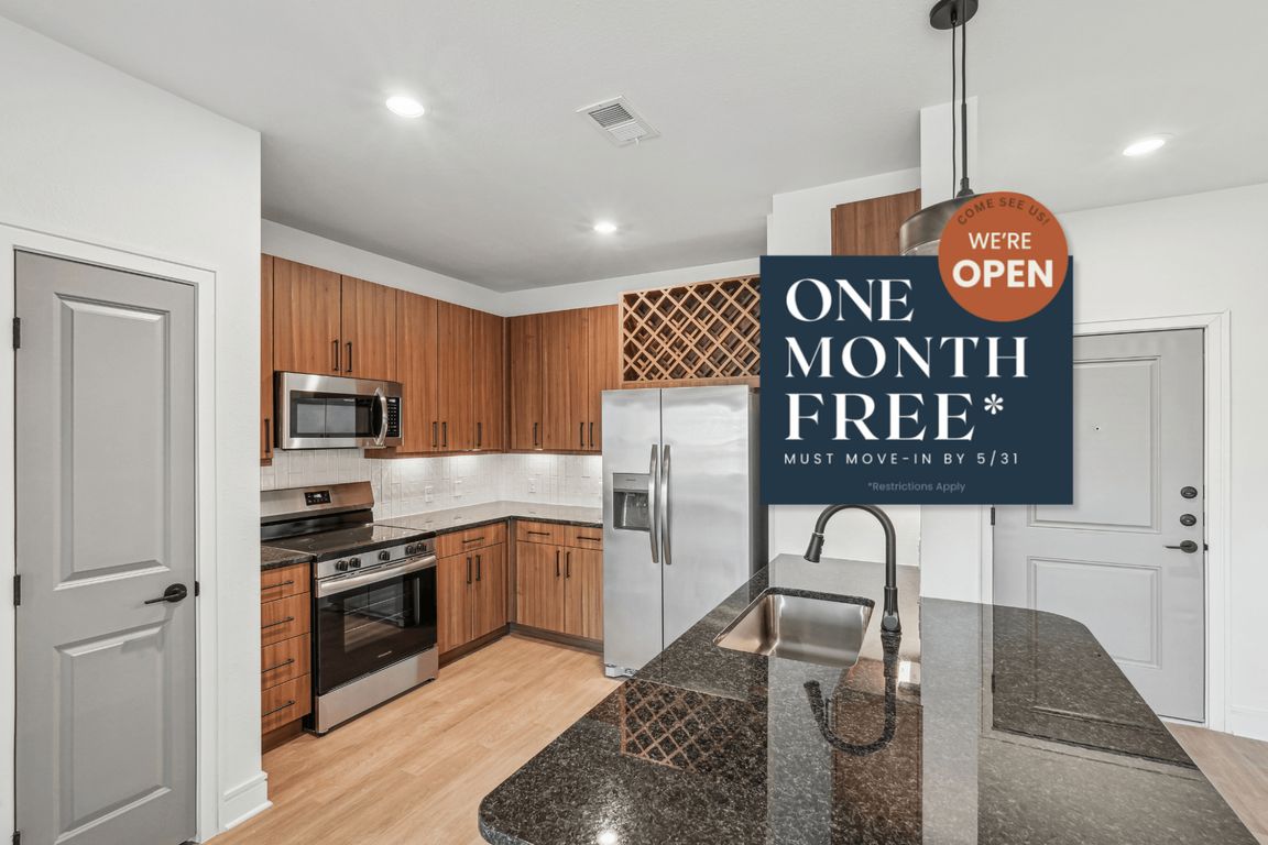 Kitchen with Granite Countertop and Stainless Steel Appliances.