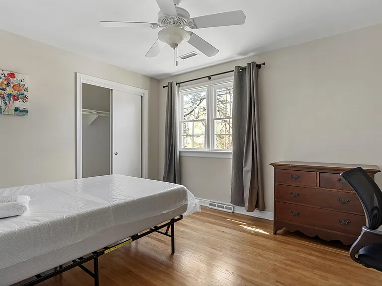 Bed room 1 - with shared bath. large window; includes a dresser, study desk, bed and bedside table.