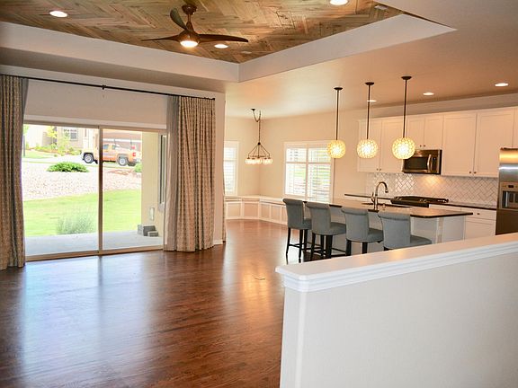 Ceiling fans in great room and bedroom, custom drapery, Bench seating in nook with storage, back covered porch with cantina lighting
