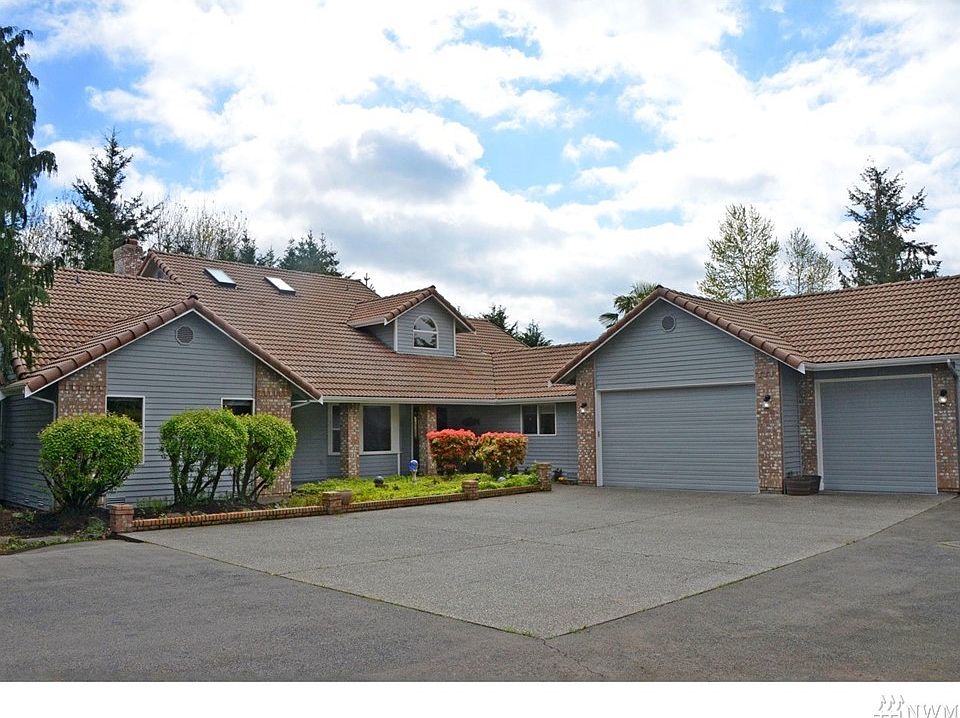 Front of home with 3 car attached garage.