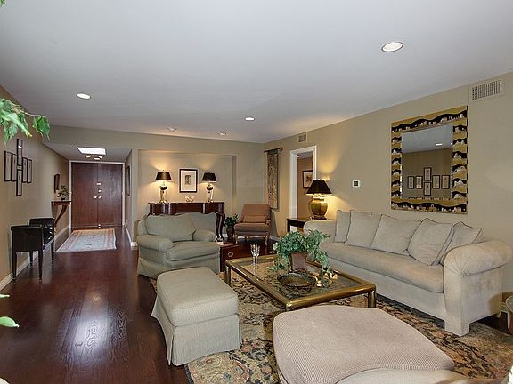 The inviting living room features recently installed gleaming hardwood floors.
