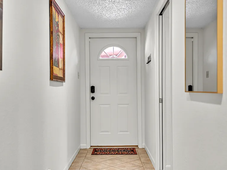 Hallway leading to side door and to the Garage