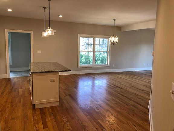 Open concept living space. Kitchen flows into dining room and living room. Half bathroom and stairs to lower level not pictured here.