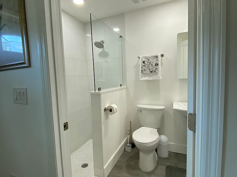 An en suite bathroom entrance with dual lighting feature.