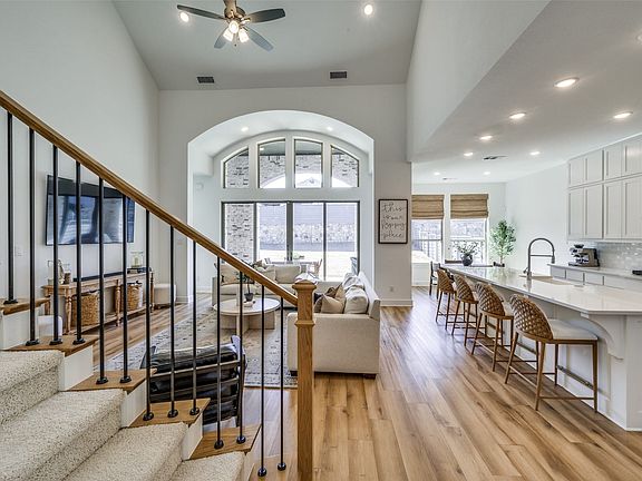 This is the amazing view from the front entry all the way back to the dramatic wall of windows.  Luxury vinyl floors are extremely durable but create a sense of attractive continuity.