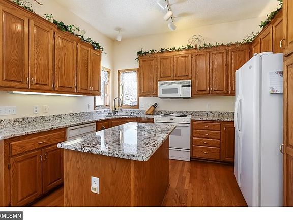 Kitchen boasts a center island and newer granite.