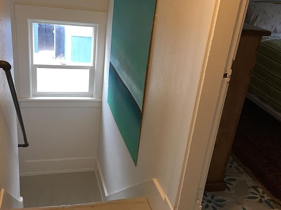 Standing in powder room looking down stairs. Bedroom Number 1 on right. Bedroom 2 on Left.