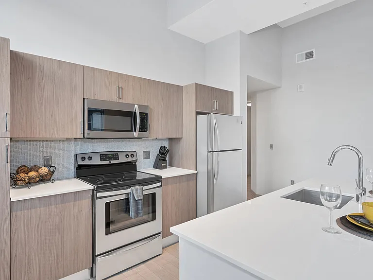 Gourmet designer kitchens with stainless steel appliances, track lighting, quartz countertops, and Italian kitchen cabinetry