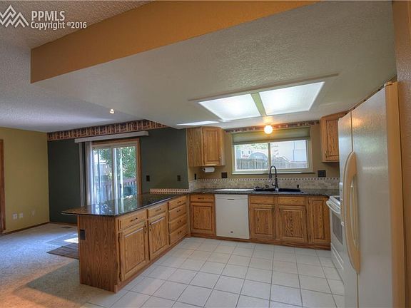 Kitchen with granite counters, tile backsplash
