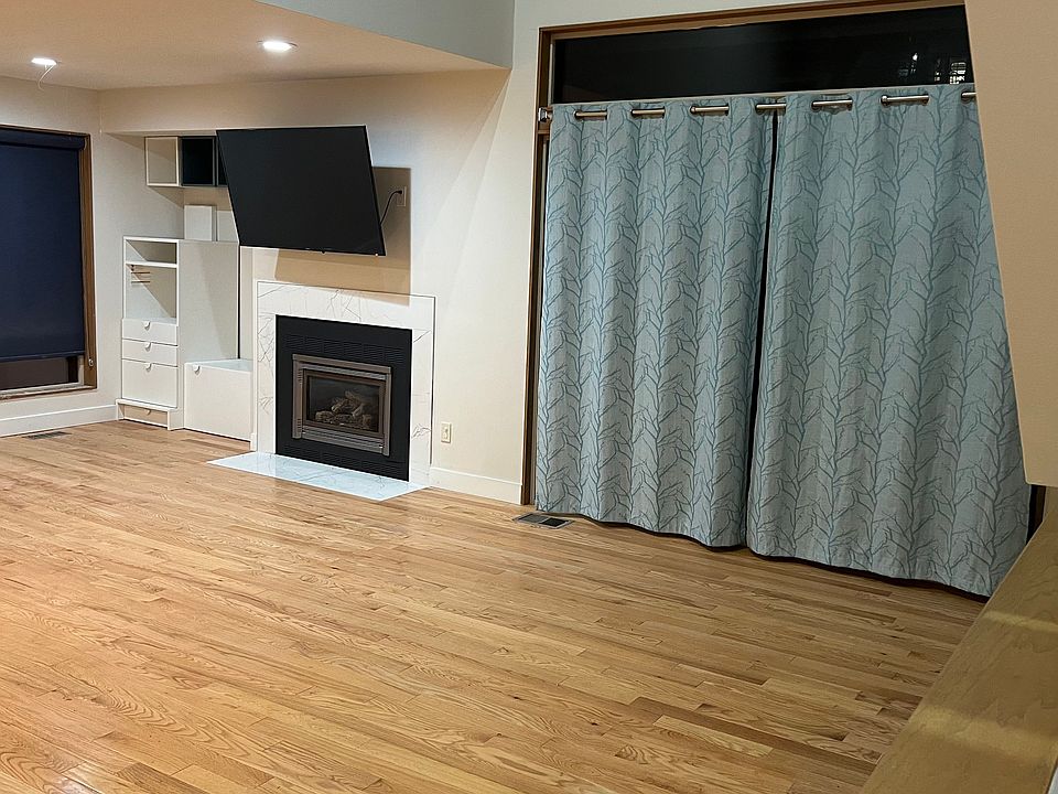 Living room with fireplace, storage, split AC