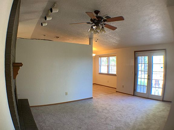Living area with french doors leading to backyard.