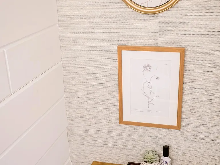 Downstairs bathroom with a wallpaper feature wall and all new toilet, sink, and matte black accessories