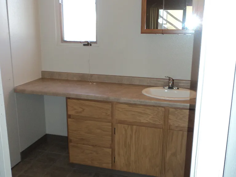 Comfortable roomy bathroom with extra storage and a shower.