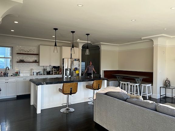 Front rm w prior tenants' furniture, looking toward kitchen
