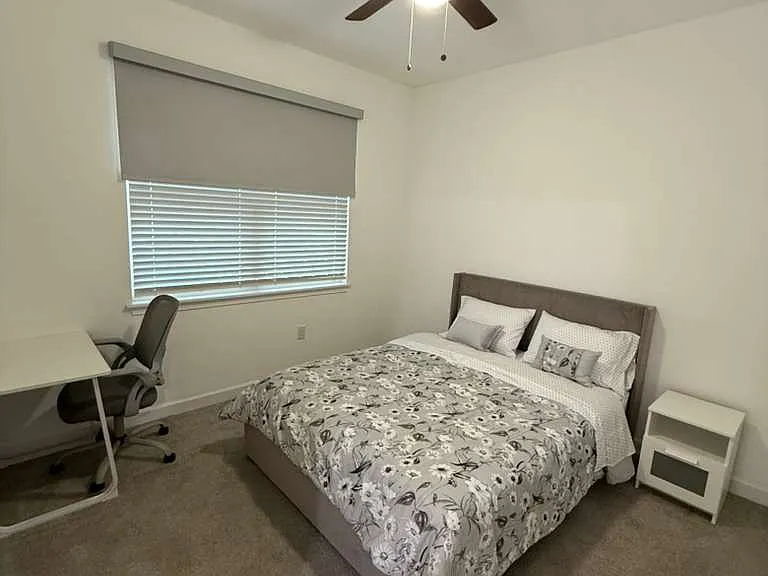 Main floor bedroom. Includes blackout blind, queen bed with matress, nightstand, and desk with chair. 
This room has a private bathroom.