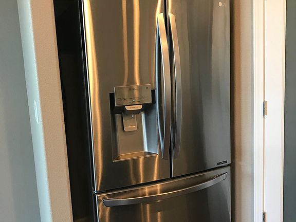 Large pantry and refrigerator in kitchen