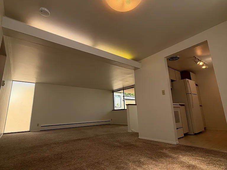 Large living and dining area, kitchen to right