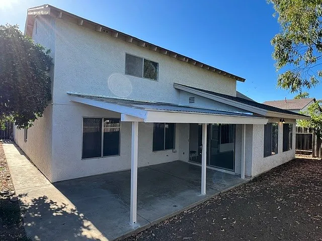 Outdoor patio, orange tree to the left