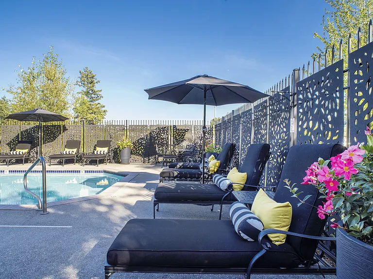 Comfortable poolside seating with shaded loungers and a relaxing outdoor atmosphere.