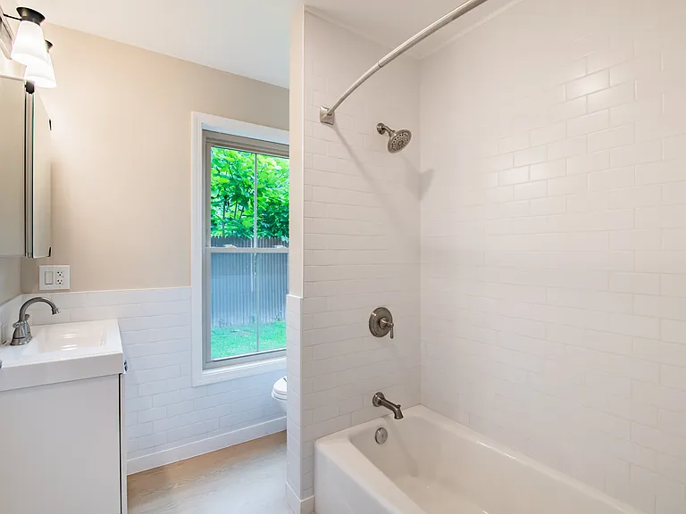 Unveil the charm of the Waterfront at the Strand, where modern design meets comfort. This beautifully updated bathroom features sleek fixtures and natural light, creating a serene retreat. Don't miss your chance to elevate your living experience today!
